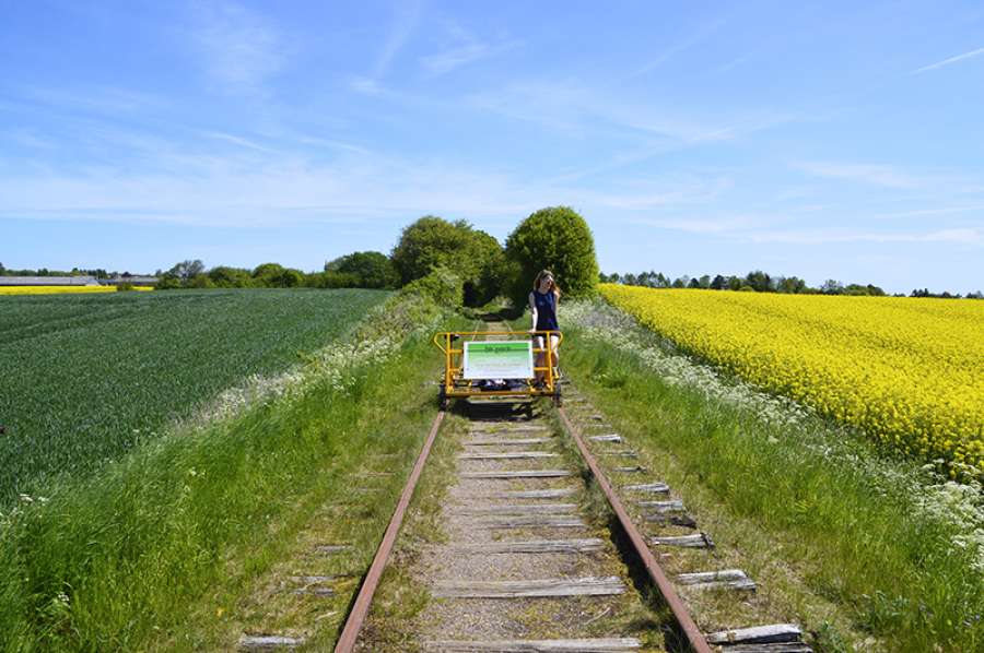 Trolley cycling through the meadows of Funen